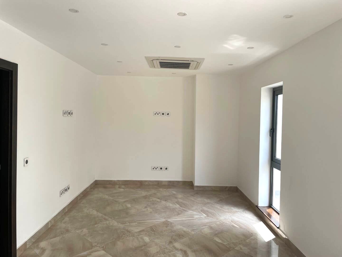 Modern living room interior with large windows and comfortable