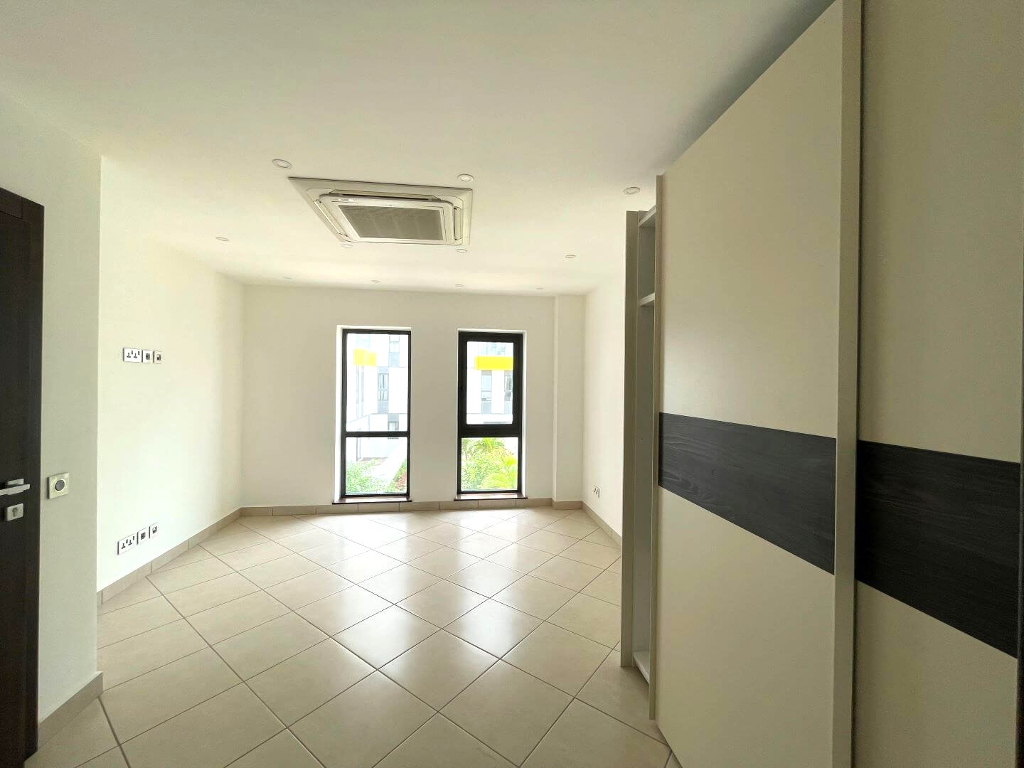 Modern living room interior with large windows and comfortable seating